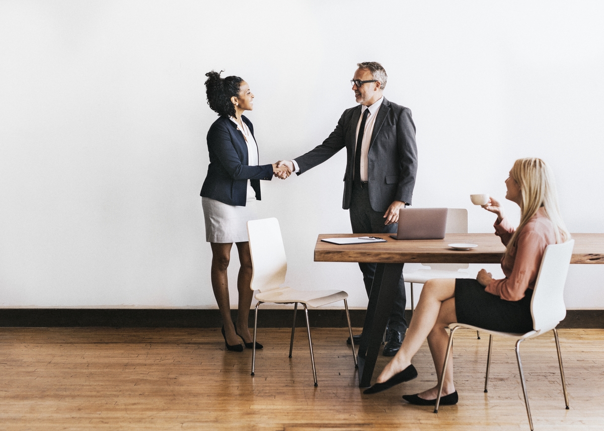 Businesswoman handshake with a businessman