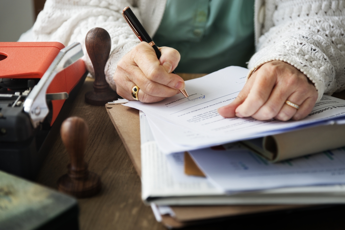 Senior woman signing a contract